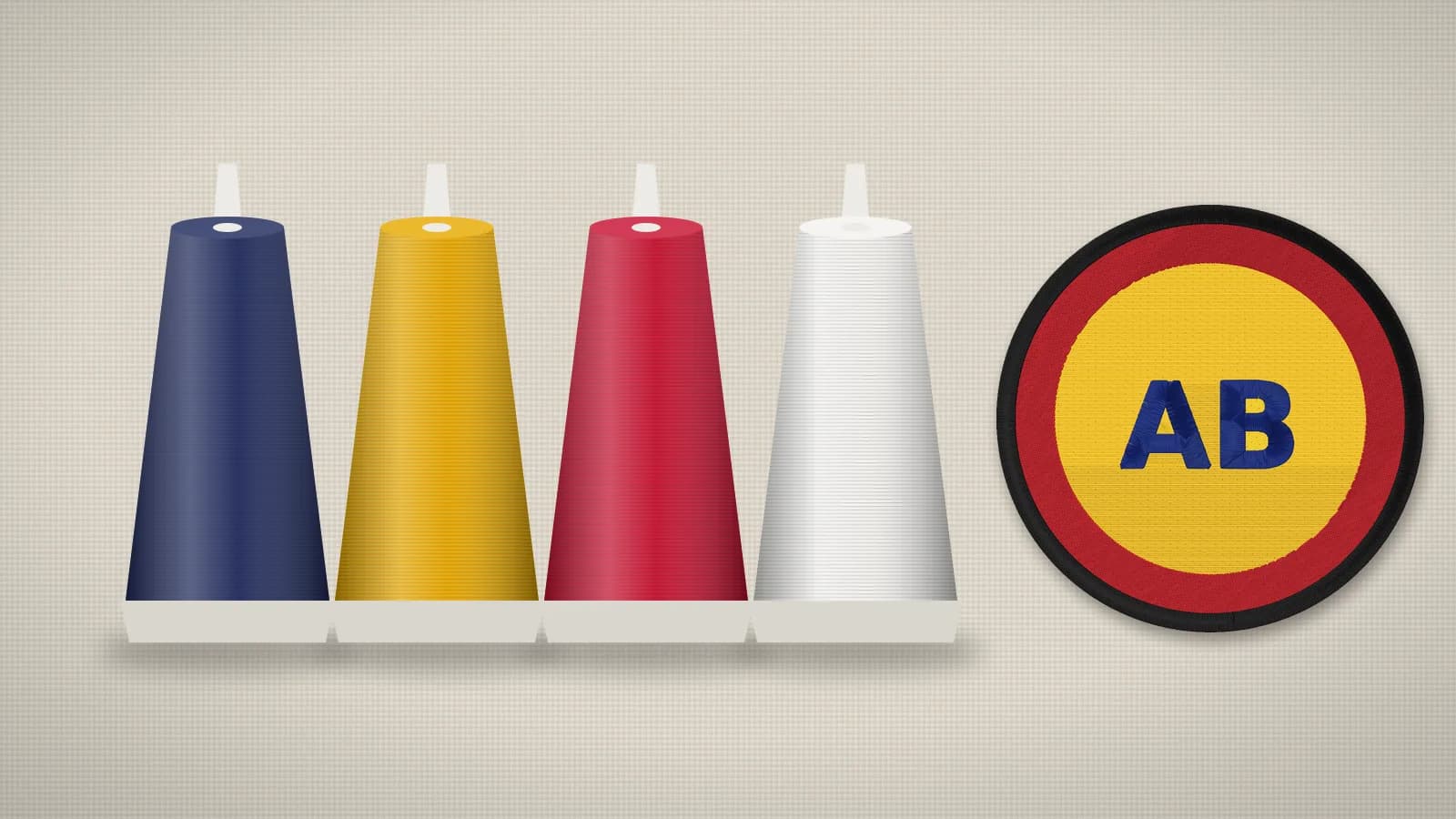 Embroidery thread cones in navy, gold, red and white beside a stitched badge