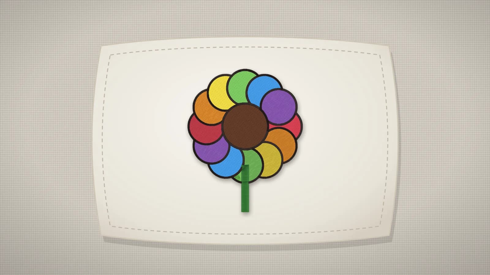 A pillow with a flower design embroidered on the front
