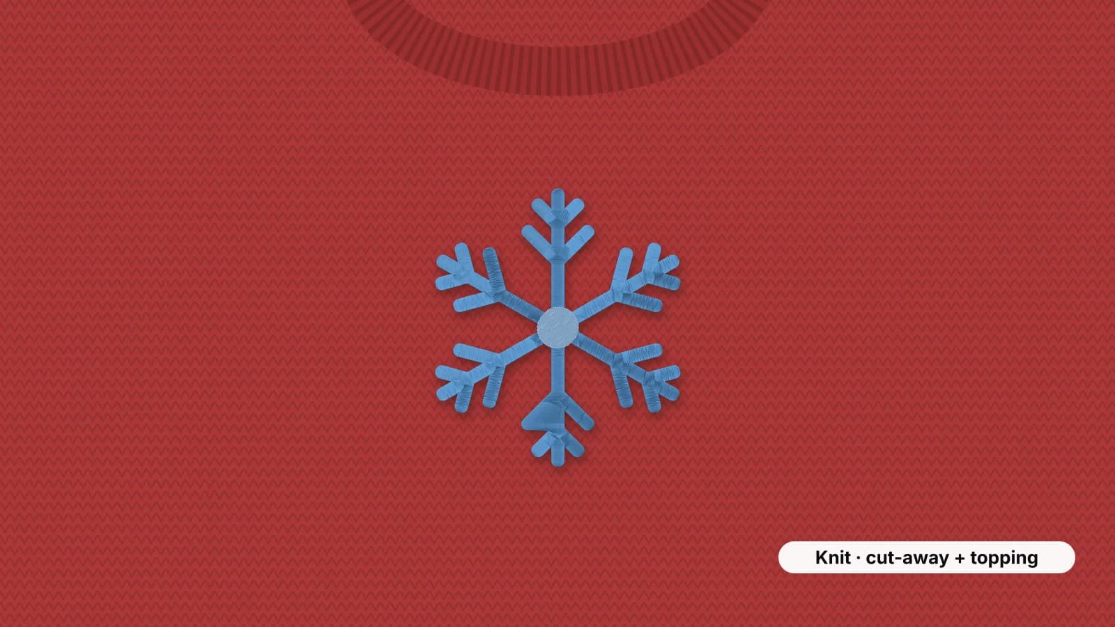 A knit sweater with a snowflake embroidered on the chest