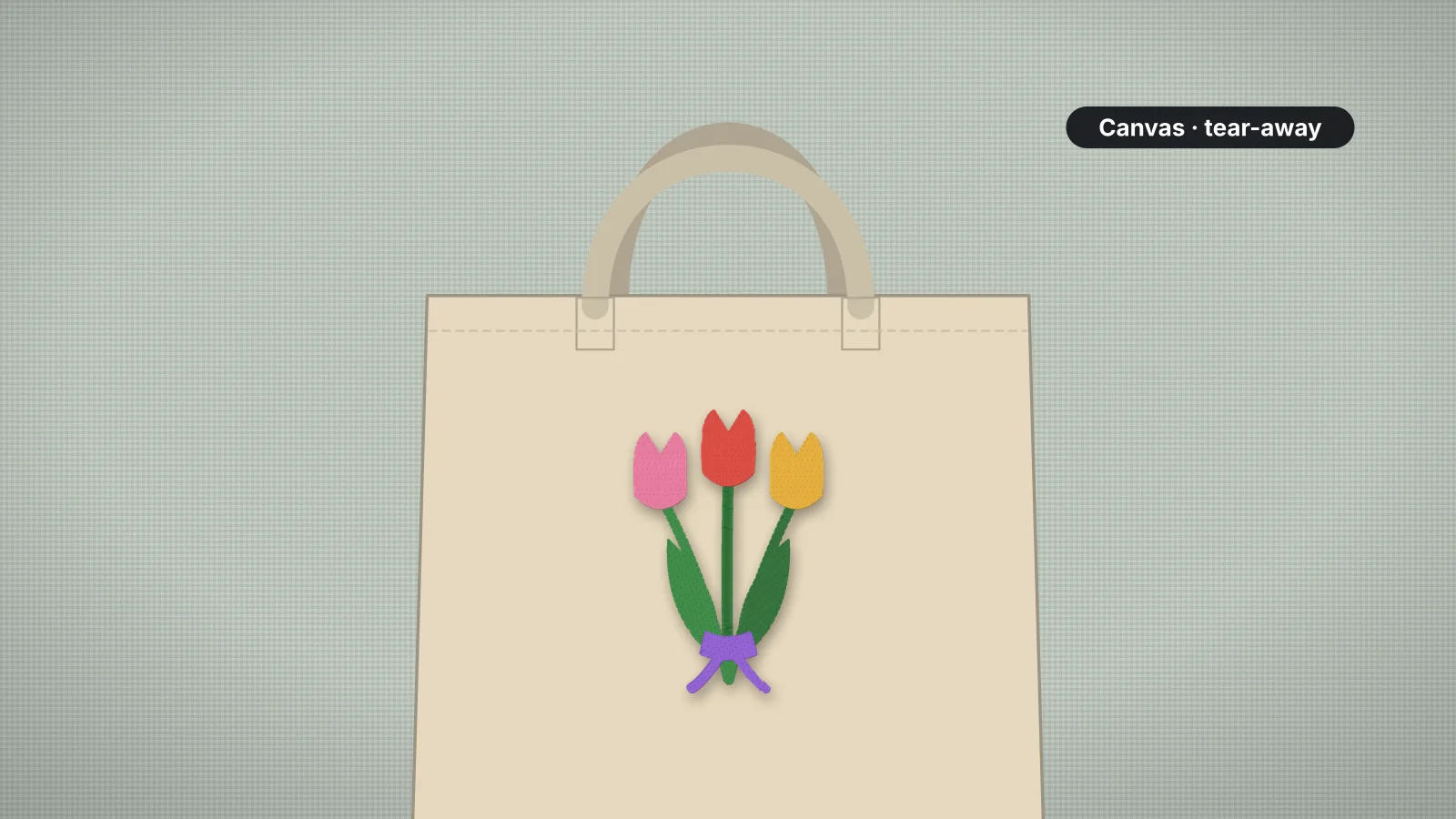 A canvas tote bag with a bunch of tulips embroidered on the front